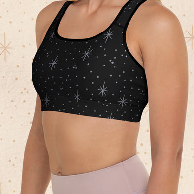 Model wearing the Overkill Tattoo Sports Bra featuring an all-over star and dot tattoo filler print in black with a racerback fit.